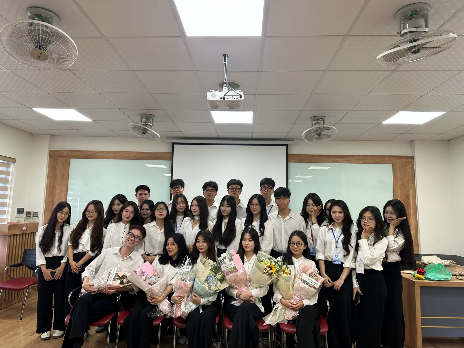 The department in white shirts with bouquets after the 2025 union conference