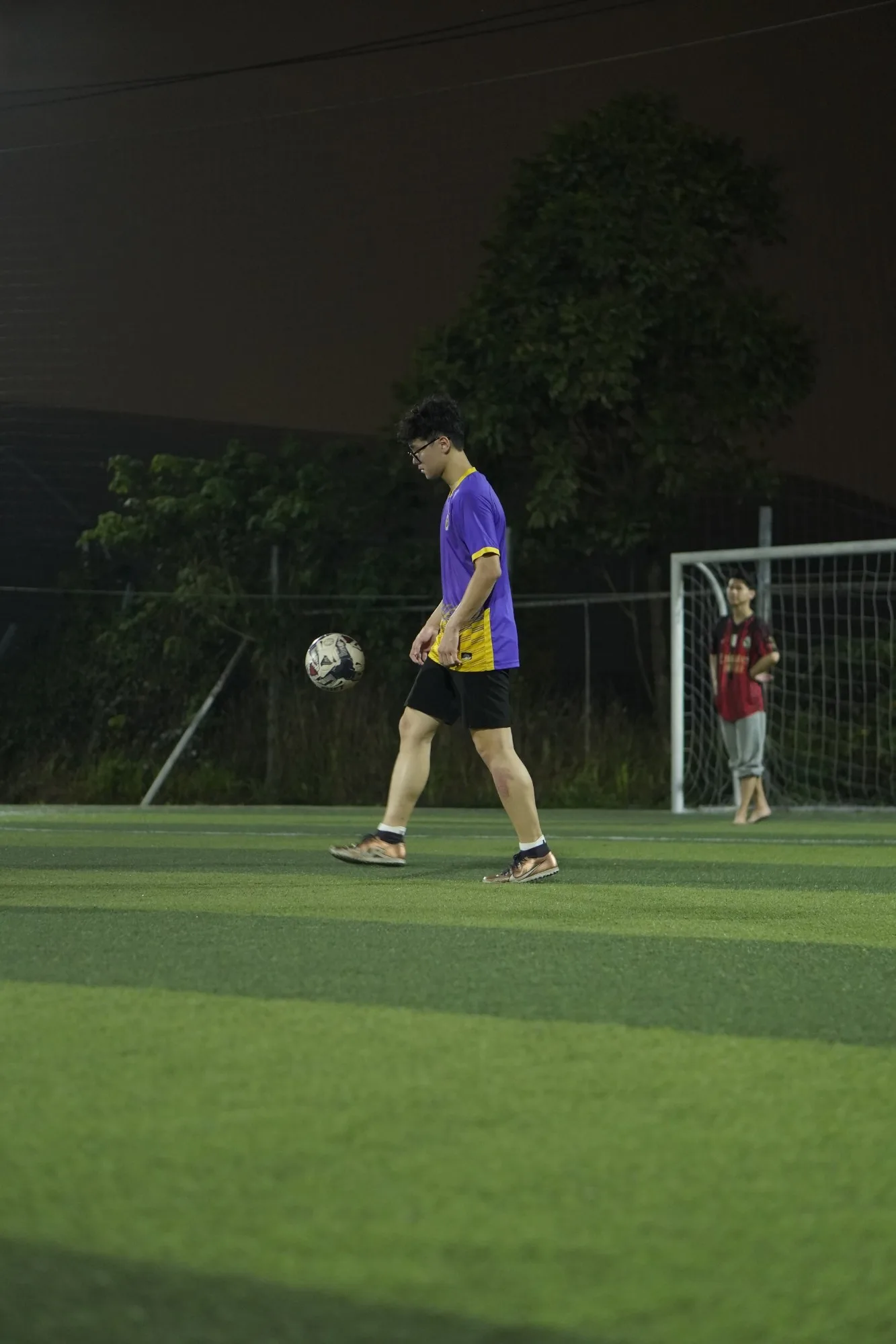 Keeping the ball up under floodlights on a five-a-side pitch