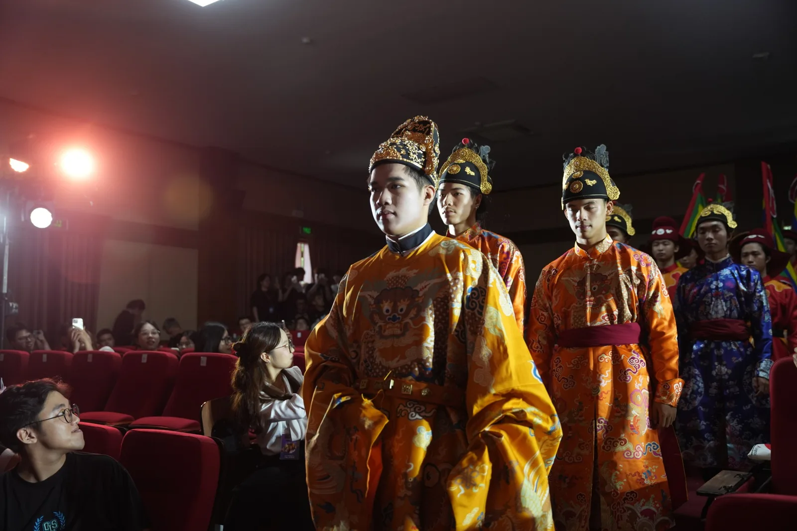 The cổ phục showcase coming down through the auditorium