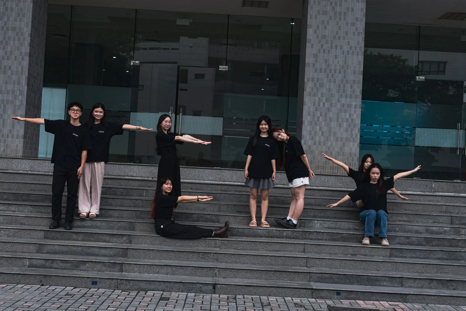 The curation department, arms out across the steps